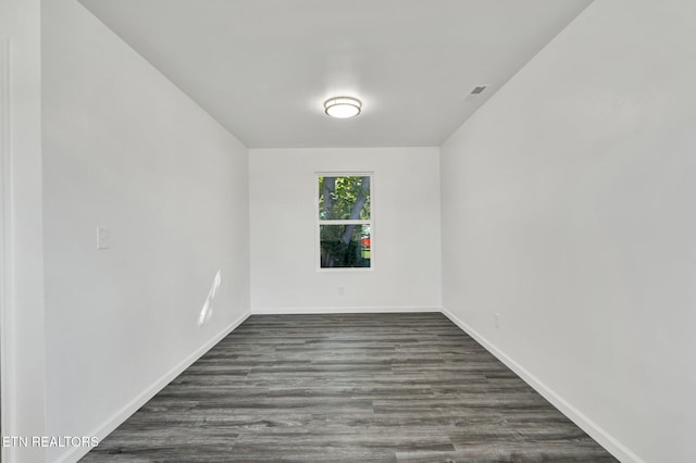 spare room featuring dark wood-type flooring