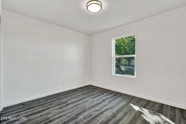 empty room with dark hardwood / wood-style floors