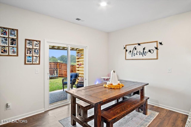 dining space featuring dark hardwood / wood-style flooring