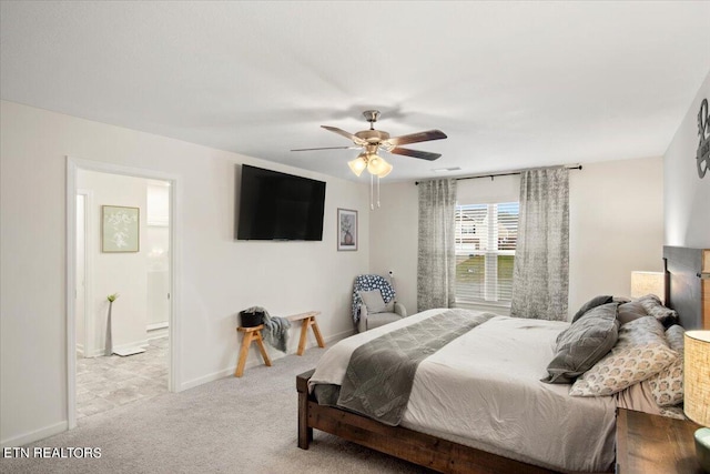 bedroom featuring ensuite bath, ceiling fan, and light colored carpet