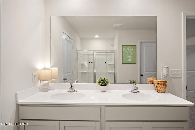 bathroom featuring an enclosed shower and vanity