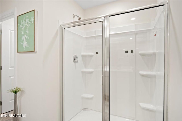 bathroom featuring a shower with shower door