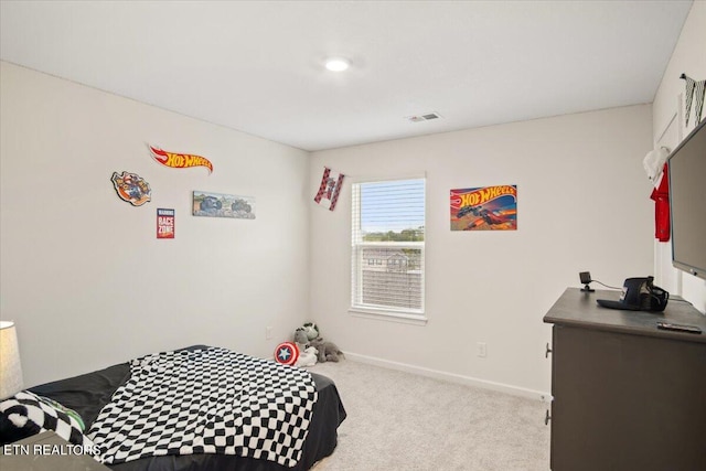 bedroom with light colored carpet