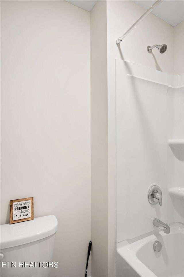 bathroom featuring toilet and  shower combination