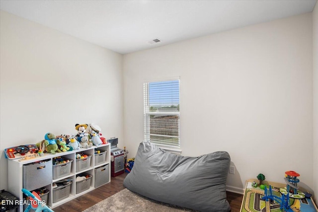 recreation room with dark wood-type flooring