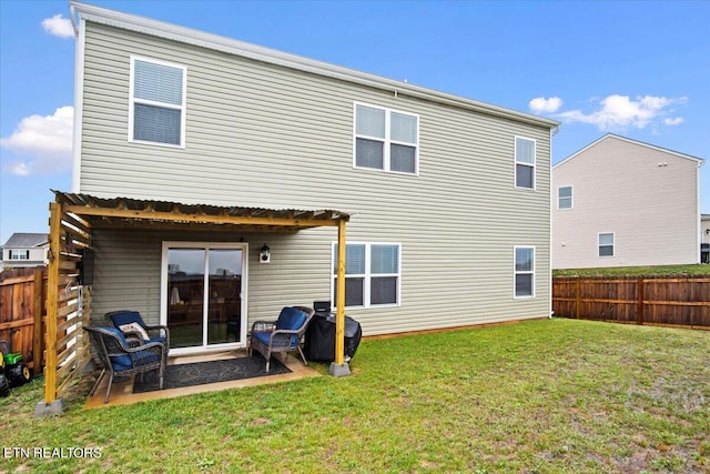 back of property with a patio area and a yard