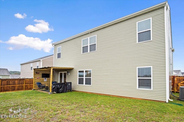 back of house featuring a lawn and a patio area