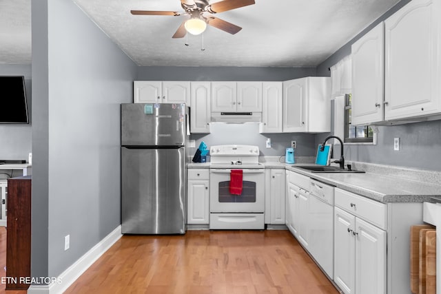 kitchen with white appliances, light hardwood / wood-style flooring, white cabinetry, ceiling fan, and sink