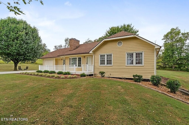 view of front facade with a front yard and a porch