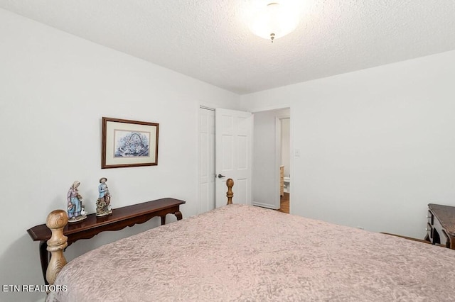 bedroom with a textured ceiling and a closet