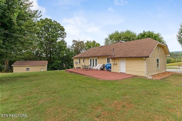 back of property featuring a lawn and a patio