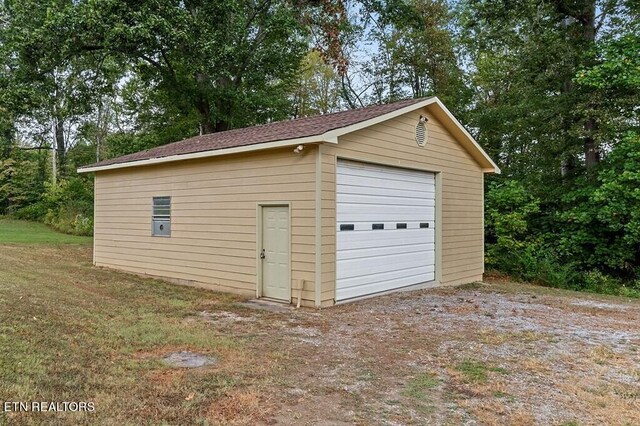 garage featuring wooden walls