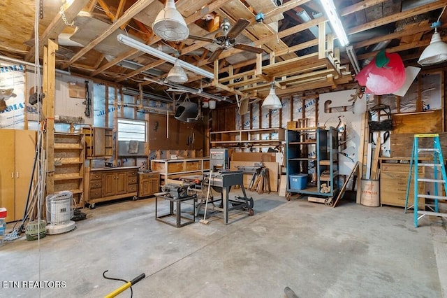 basement featuring a workshop area and ceiling fan