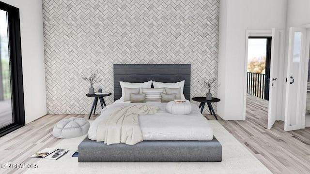 bedroom featuring access to outside, light wood-type flooring, and tile walls