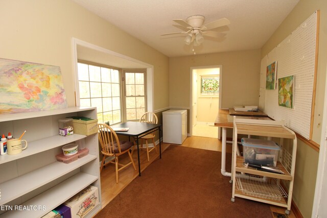 office area with wood-type flooring and ceiling fan