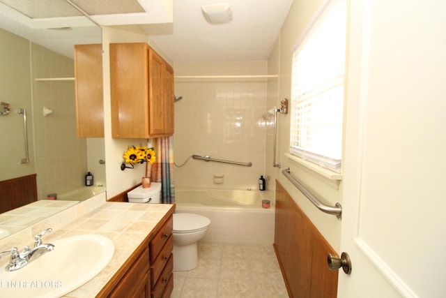 full bathroom featuring tiled shower / bath, vanity, toilet, and tile patterned floors