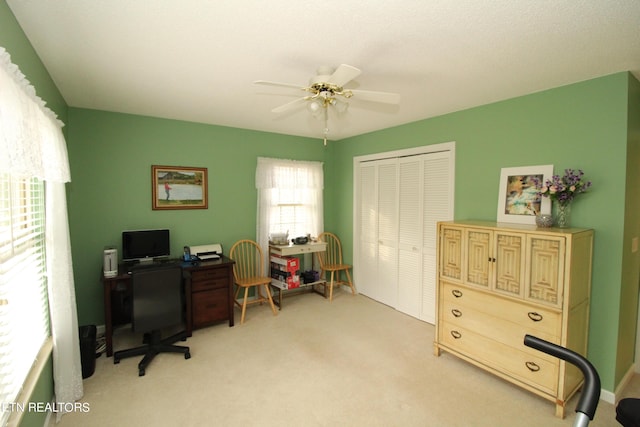 home office featuring ceiling fan and light carpet