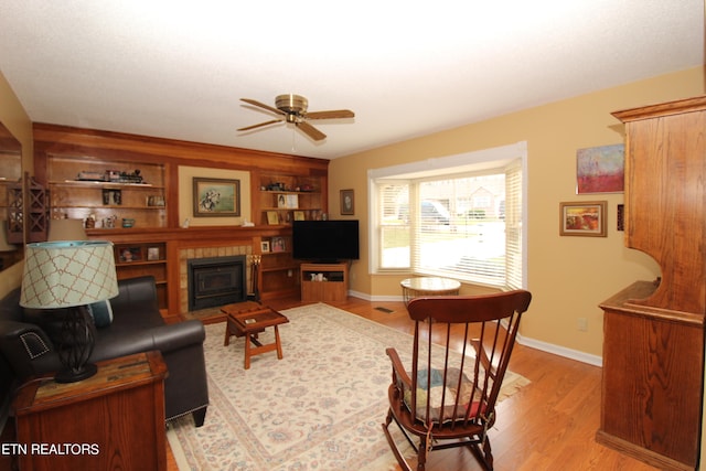 living room with ceiling fan and light hardwood / wood-style flooring