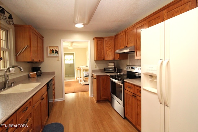 kitchen featuring a sink, white fridge with ice dispenser, dishwashing machine, under cabinet range hood, and stainless steel electric stove
