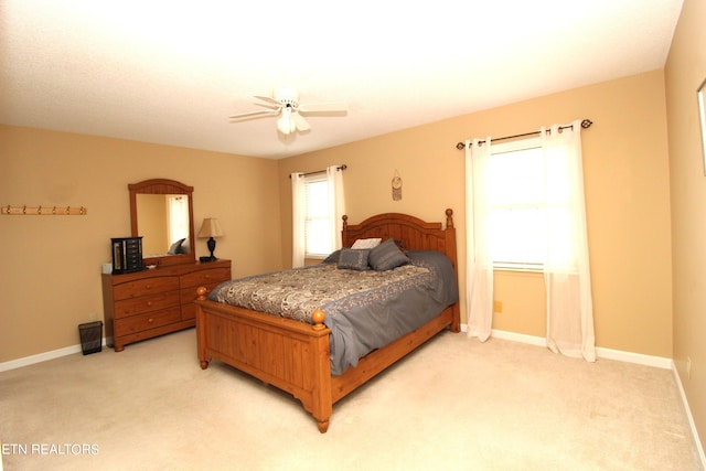 bedroom with ceiling fan and light colored carpet