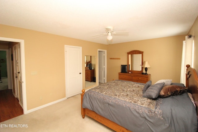 carpeted bedroom with baseboards and ceiling fan