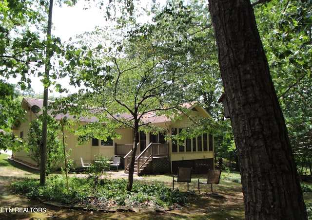 back of property featuring a patio and a sunroom