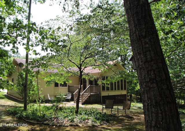 back of property featuring a sunroom