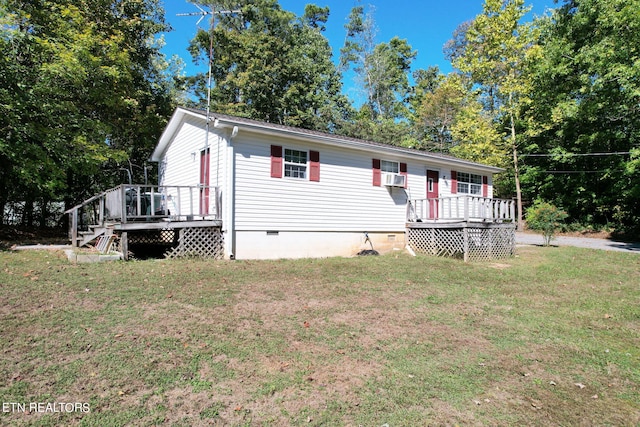 view of front facade featuring cooling unit, a wooden deck, and a front lawn