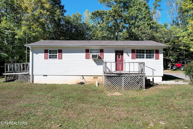 view of front of house with a front lawn, a wooden deck, and cooling unit