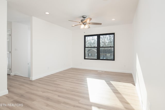 spare room featuring ceiling fan and light wood-type flooring