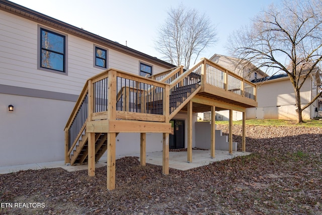 back of property with a patio and a deck