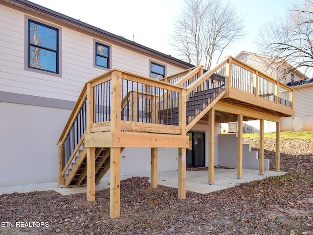 back of property featuring a patio area and a deck