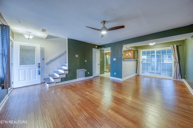 unfurnished living room with light hardwood / wood-style flooring and ceiling fan