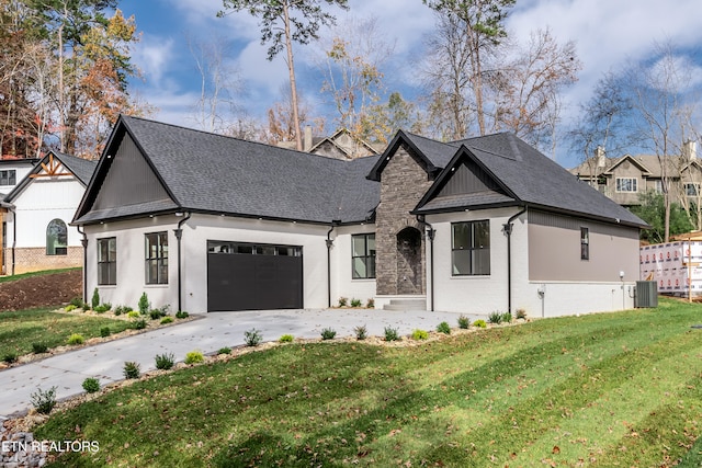 view of front of house featuring a garage, central air condition unit, and a front lawn