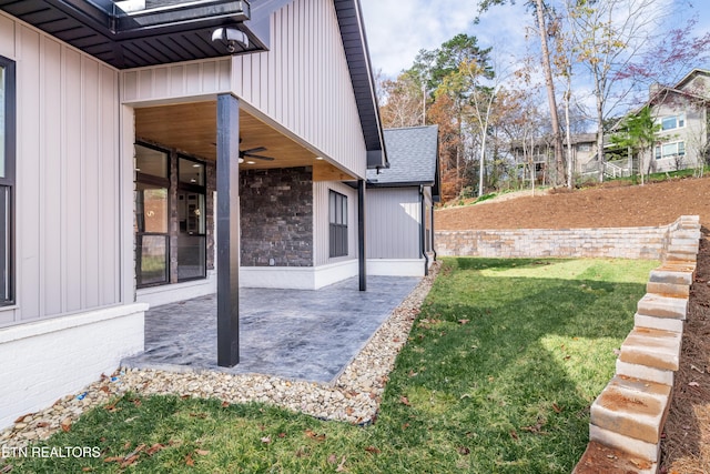 view of yard with a patio and ceiling fan