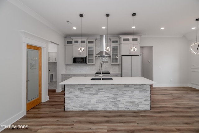 200 Kawga Ln, Loudon, TN 37774 - kitchen with wall chimney range hood, freestanding refrigerator, stainless steel microwave, a kitchen island with sink, and light countertops