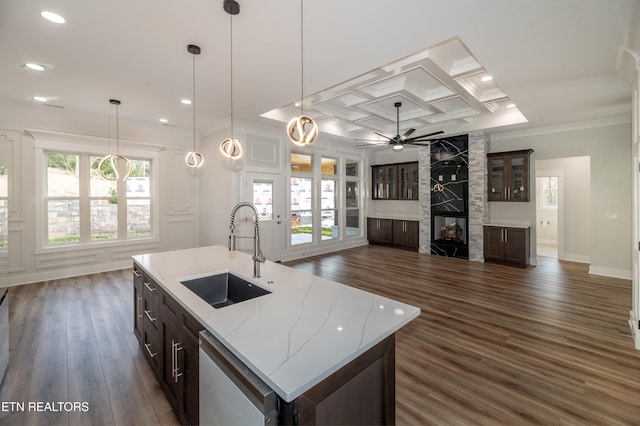 kitchen with dishwashing machine, a fireplace, coffered ceiling, a sink, and crown molding