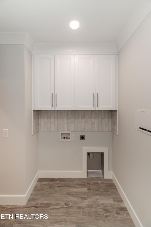 laundry area featuring washer hookup, cabinet space, hookup for an electric dryer, and baseboards