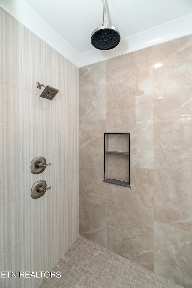 bathroom with tiled shower