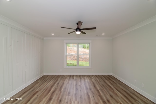 spare room with recessed lighting, baseboards, wood finished floors, and ornamental molding