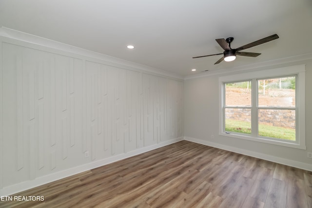 unfurnished room with ornamental molding, recessed lighting, wood finished floors, and baseboards