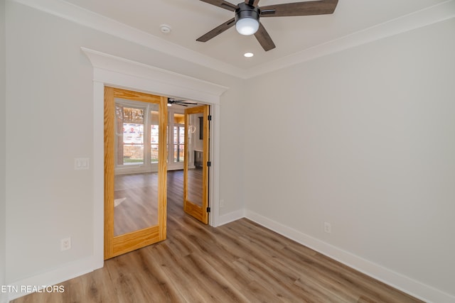 spare room featuring a ceiling fan, recessed lighting, light wood-style flooring, and baseboards