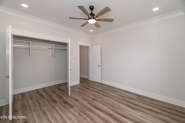 unfurnished bedroom with crown molding, recessed lighting, wood finished floors, and baseboards