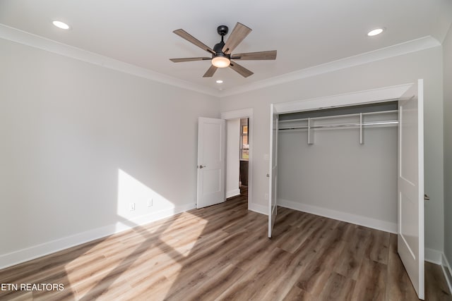 unfurnished bedroom featuring ornamental molding, baseboards, and wood finished floors