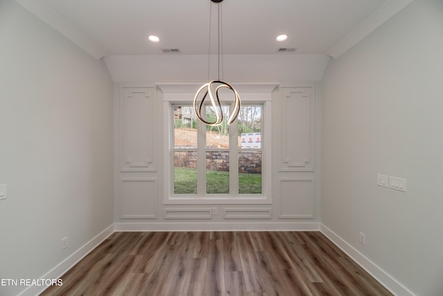 unfurnished dining area featuring wood finished floors, visible vents, and baseboards