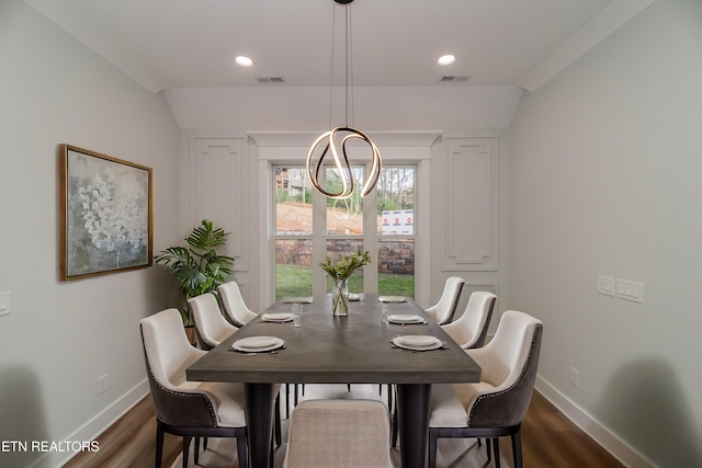 dining area featuring baseboards, visible vents, and dark wood finished floors