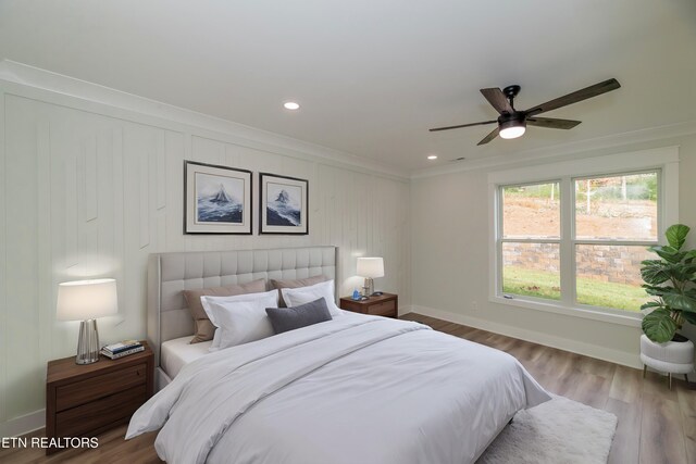 bedroom with crown molding, recessed lighting, ceiling fan, wood finished floors, and baseboards