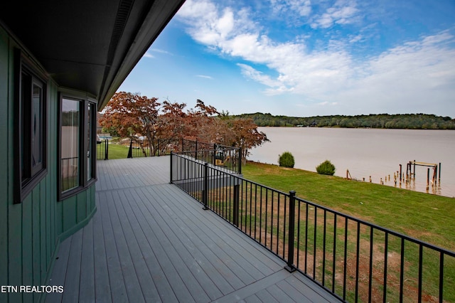 deck featuring a water view and a yard