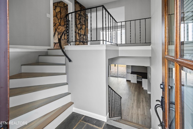 staircase with hardwood / wood-style flooring