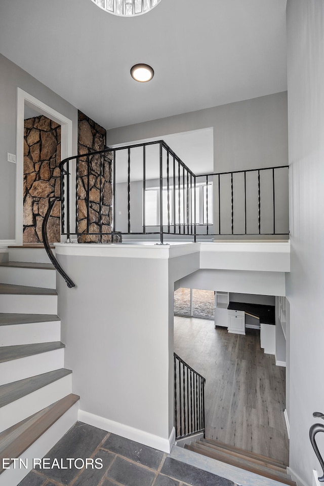 stairs featuring wood-type flooring